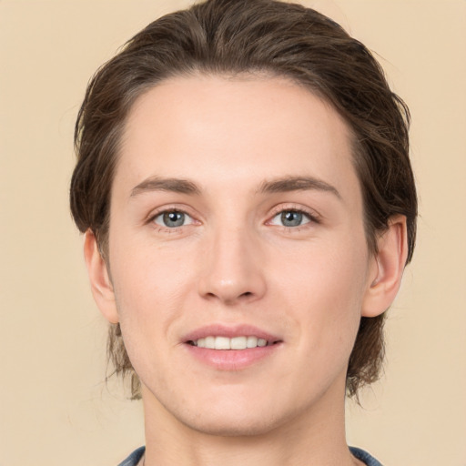 Joyful white young-adult female with medium  brown hair and grey eyes