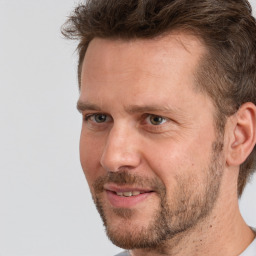 Joyful white adult male with short  brown hair and grey eyes