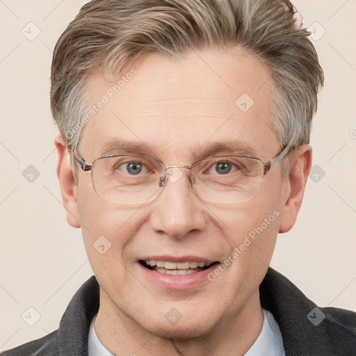 Joyful white middle-aged male with short  brown hair and grey eyes