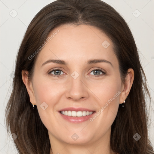 Joyful white adult female with long  brown hair and brown eyes