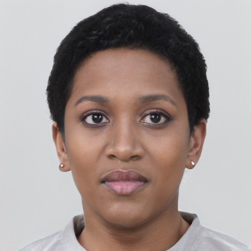 Joyful black young-adult female with short  black hair and brown eyes