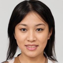 Joyful asian young-adult female with medium  brown hair and brown eyes