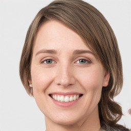 Joyful white young-adult female with medium  brown hair and green eyes