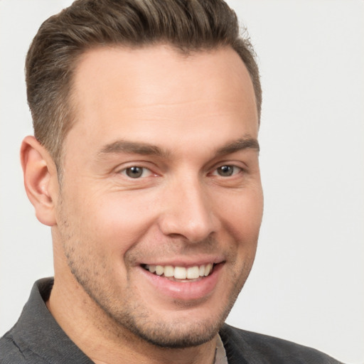 Joyful white young-adult male with short  brown hair and brown eyes