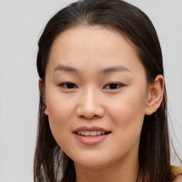 Joyful asian young-adult female with long  brown hair and brown eyes