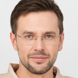 Joyful white adult male with short  brown hair and grey eyes