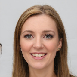 Joyful white young-adult female with long  brown hair and grey eyes