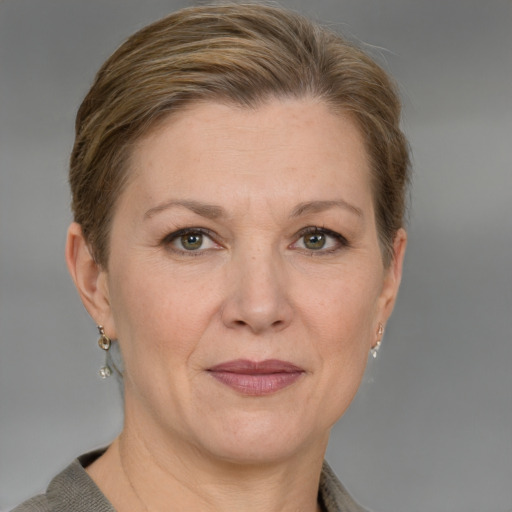 Joyful white adult female with short  brown hair and grey eyes