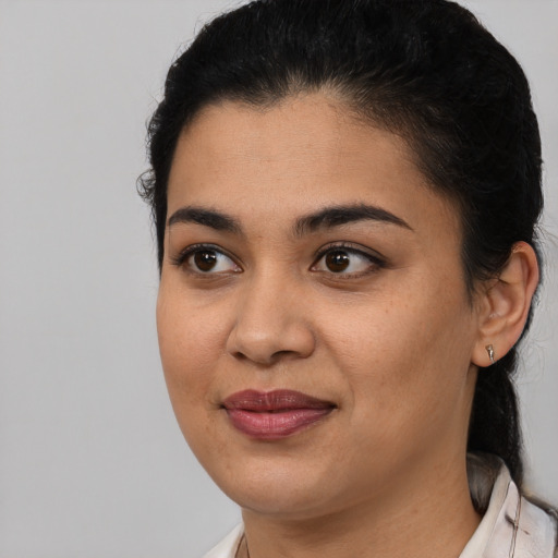 Joyful latino young-adult female with medium  black hair and brown eyes