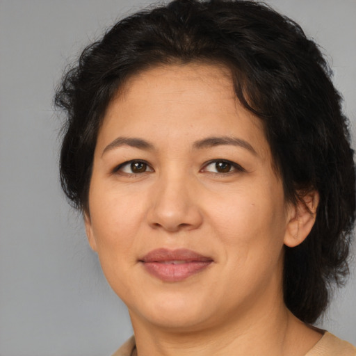 Joyful asian adult female with medium  brown hair and brown eyes