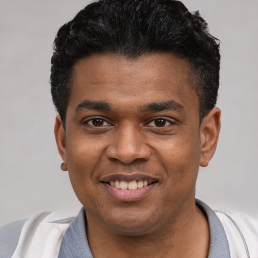 Joyful latino young-adult male with short  black hair and brown eyes