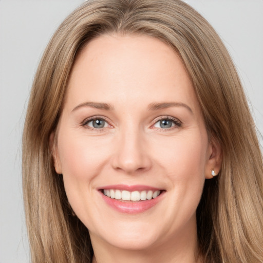 Joyful white young-adult female with long  brown hair and green eyes