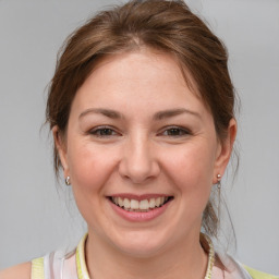 Joyful white young-adult female with medium  brown hair and brown eyes