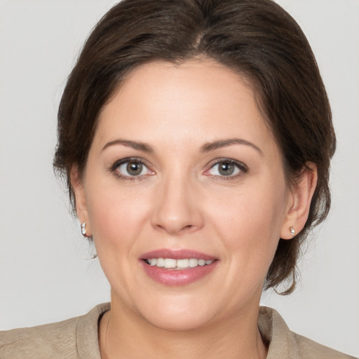 Joyful white adult female with medium  brown hair and brown eyes