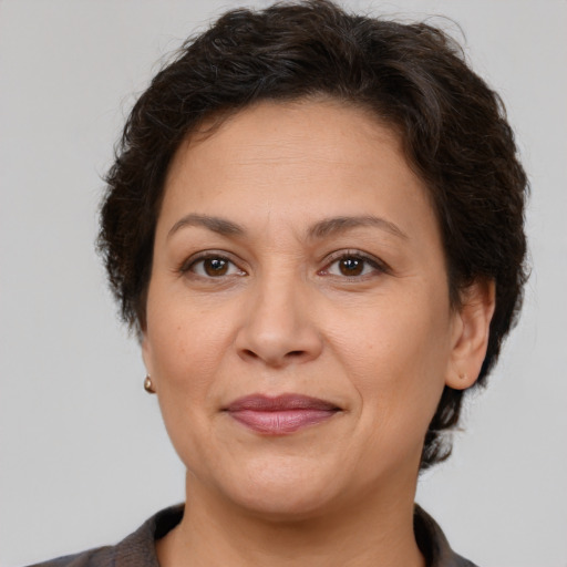 Joyful white adult female with short  brown hair and brown eyes