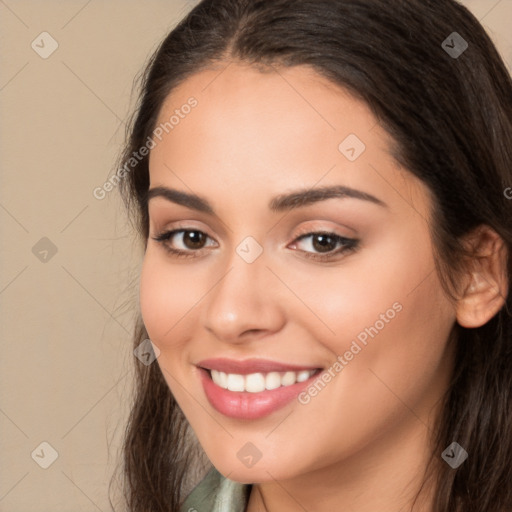 Joyful white young-adult female with long  brown hair and brown eyes