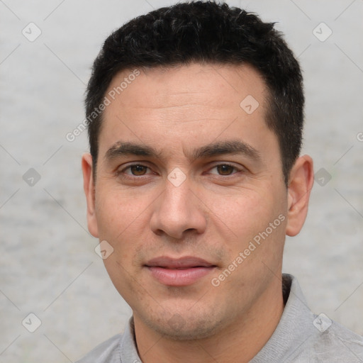 Joyful white young-adult male with short  black hair and brown eyes