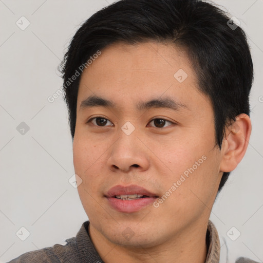 Joyful asian young-adult male with short  brown hair and brown eyes