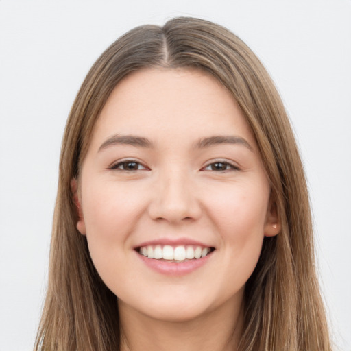 Joyful white young-adult female with long  brown hair and brown eyes