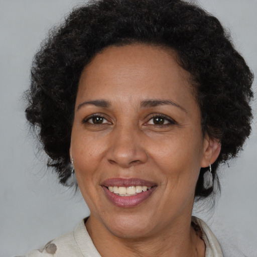 Joyful black adult female with short  brown hair and brown eyes