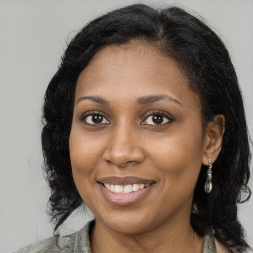 Joyful black young-adult female with medium  brown hair and brown eyes