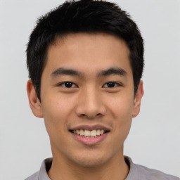 Joyful asian young-adult male with short  black hair and brown eyes