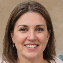 Joyful white adult female with medium  brown hair and brown eyes