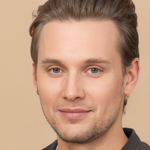 Joyful white young-adult male with short  brown hair and brown eyes