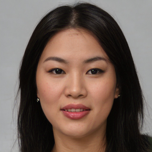 Joyful asian young-adult female with long  brown hair and brown eyes