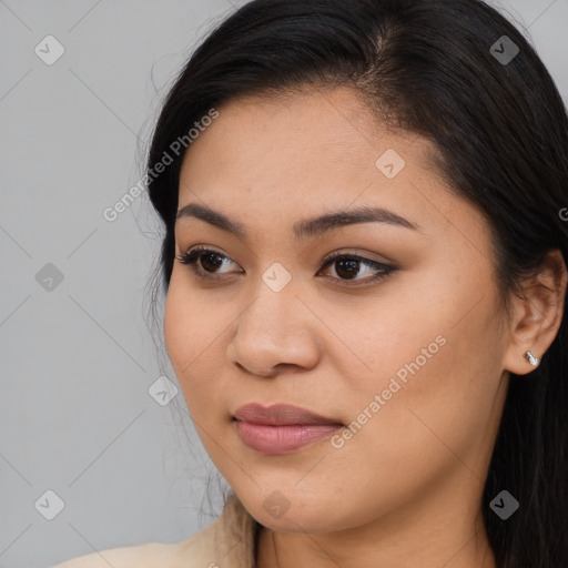 Joyful asian young-adult female with long  brown hair and brown eyes