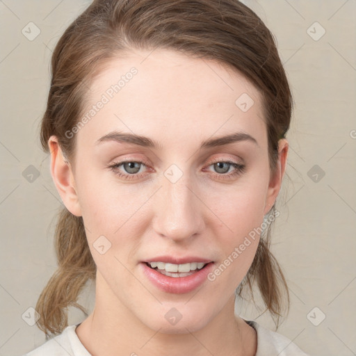 Joyful white young-adult female with medium  brown hair and grey eyes