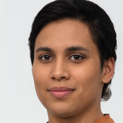 Joyful latino young-adult female with short  black hair and brown eyes