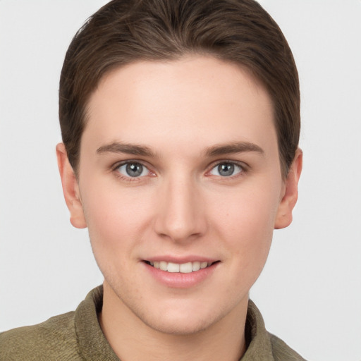 Joyful white young-adult female with short  brown hair and grey eyes