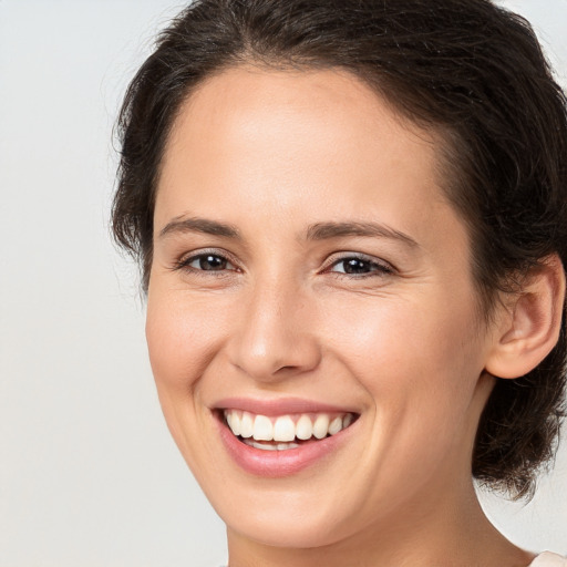 Joyful white young-adult female with medium  brown hair and brown eyes