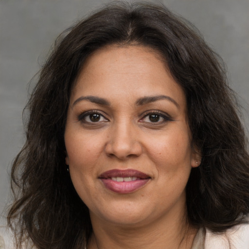 Joyful white adult female with long  brown hair and brown eyes