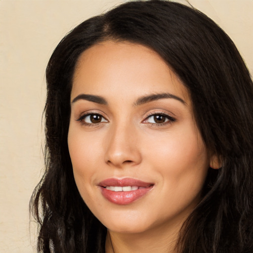 Joyful latino young-adult female with long  black hair and brown eyes