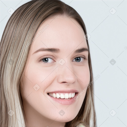 Joyful white young-adult female with long  brown hair and grey eyes