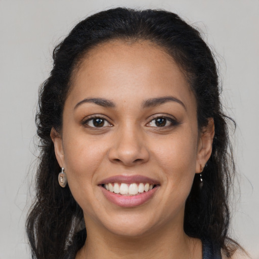 Joyful latino young-adult female with long  brown hair and brown eyes