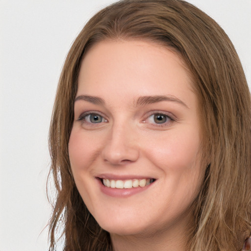 Joyful white young-adult female with long  brown hair and grey eyes