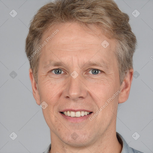 Joyful white adult male with short  brown hair and grey eyes