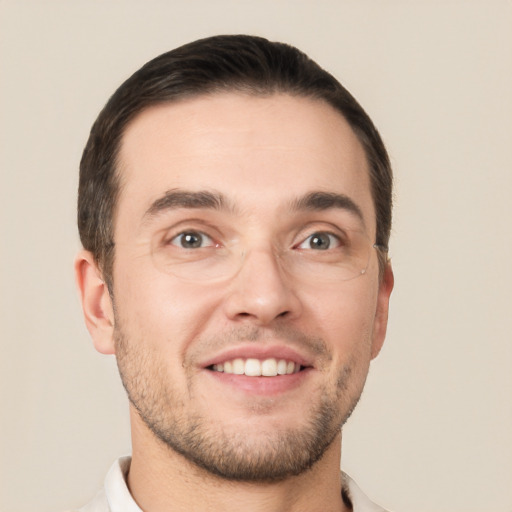 Joyful white young-adult male with short  brown hair and brown eyes