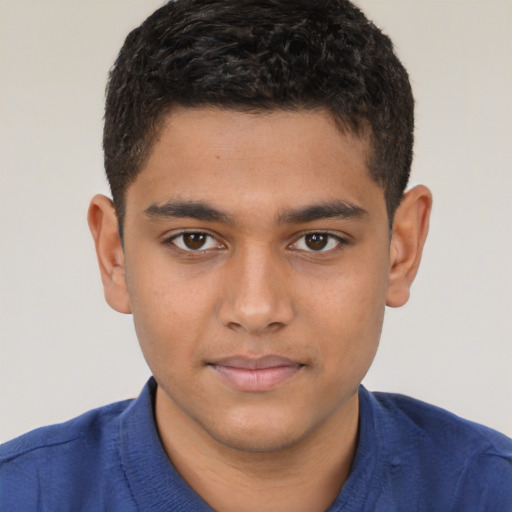 Joyful latino child male with short  brown hair and brown eyes