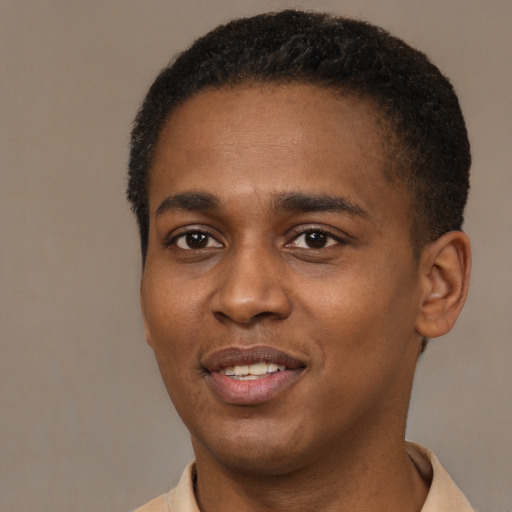 Joyful black young-adult male with short  brown hair and brown eyes