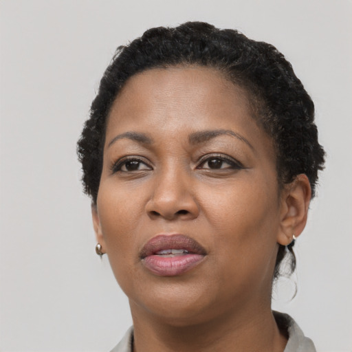 Joyful black adult female with short  black hair and brown eyes