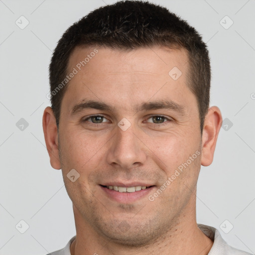 Joyful white young-adult male with short  brown hair and brown eyes