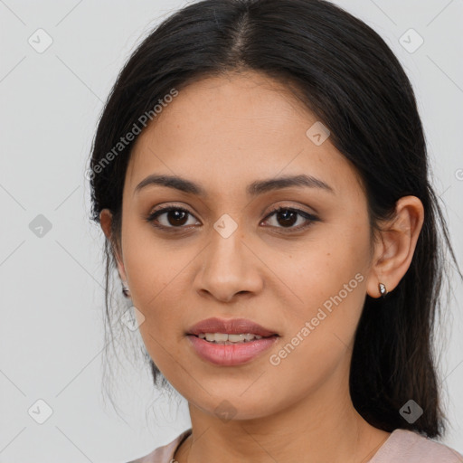 Joyful latino young-adult female with long  brown hair and brown eyes