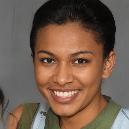 Joyful black young-adult female with short  brown hair and brown eyes