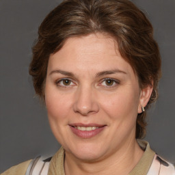 Joyful white adult female with medium  brown hair and brown eyes