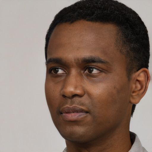 Neutral black young-adult male with short  black hair and brown eyes