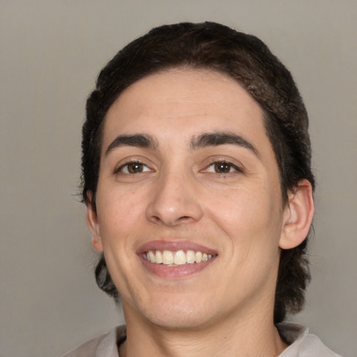 Joyful white young-adult male with medium  black hair and brown eyes